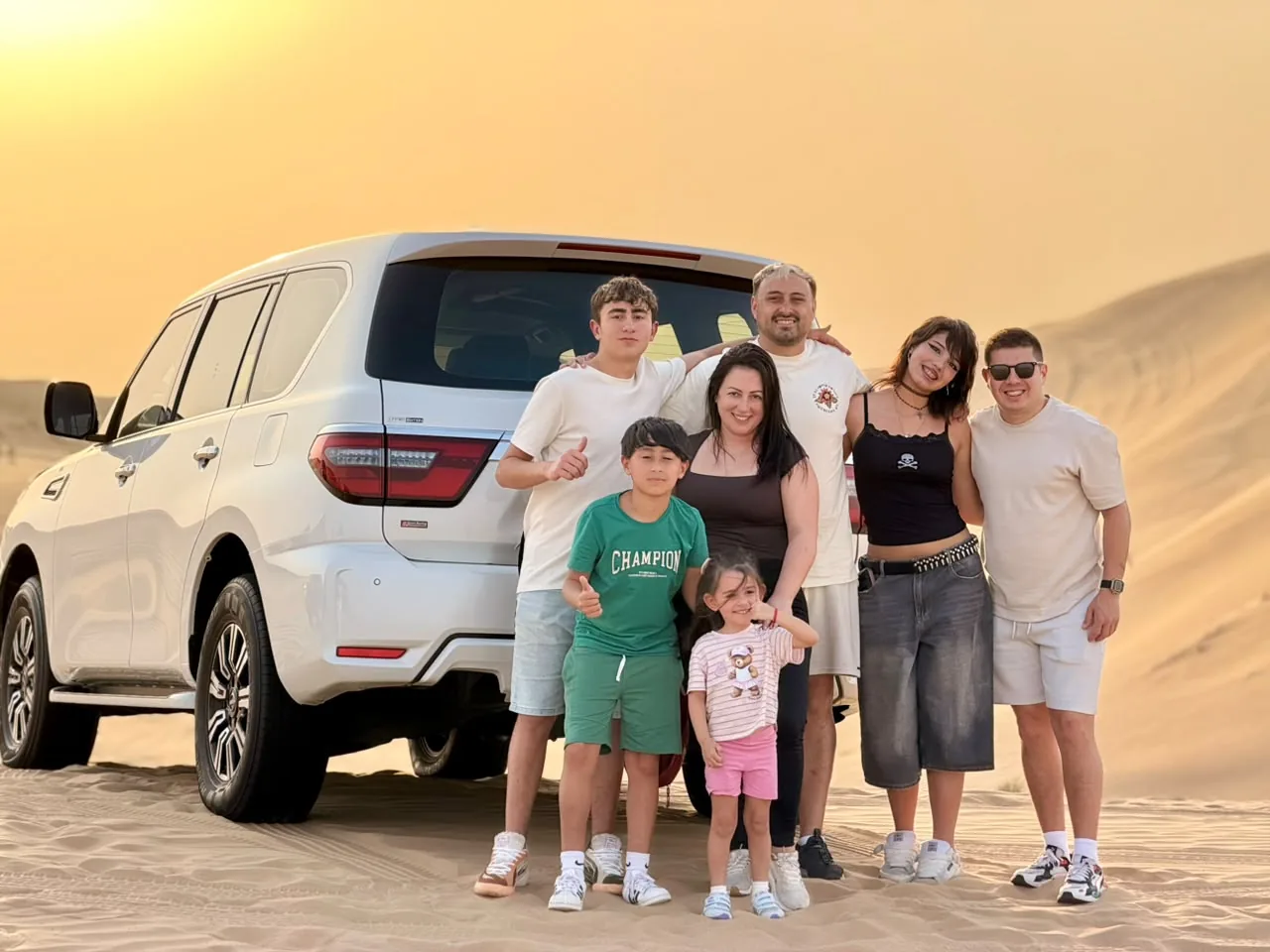 Family with a 4x4 at sunrise during a private morning desert safari